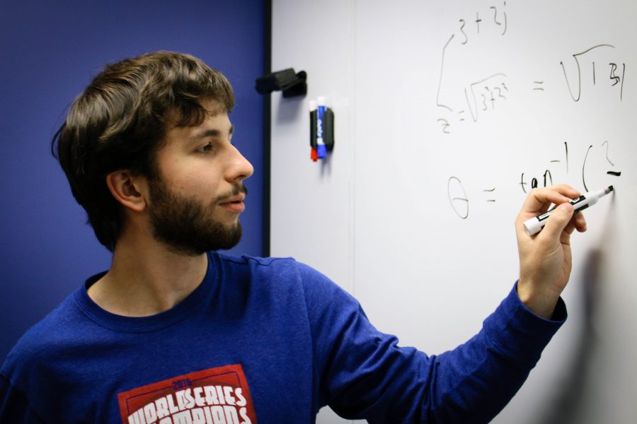 Matthew Kresich, junior mechanical engineering major, works out some math problems in the Honors College Lounge. 