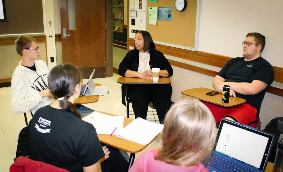 Karen Bishop-Morris, center, hosts a group discussion with students. 