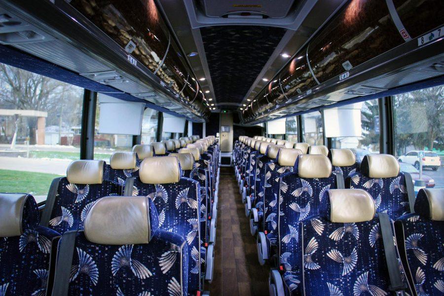 The buses for bringing students and faculty members between campuses have hardwood floors, footrests, televisions, a restroom, overhead storage and adjustable lighting.