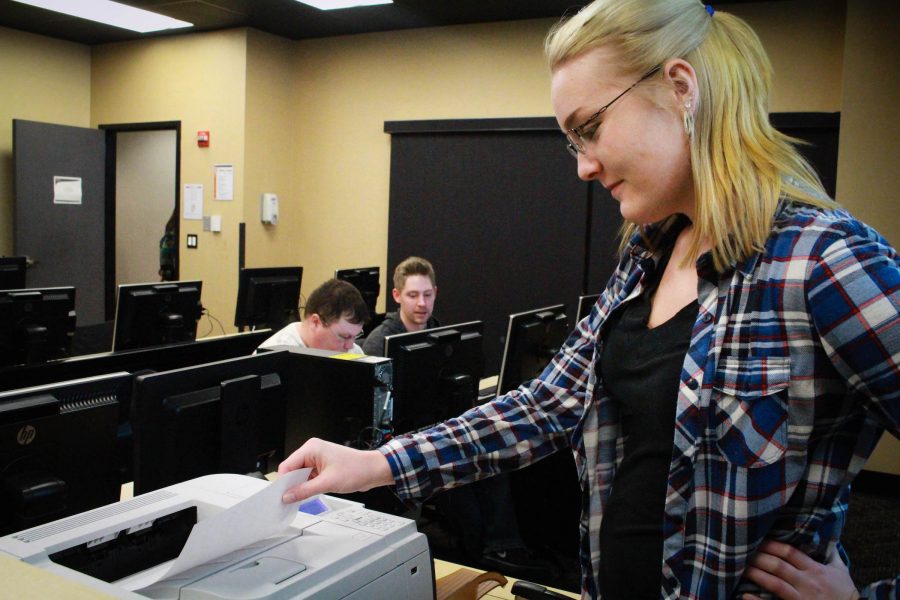 Nicole Ward, senior computer graphic design major, prints out her homework before class. 