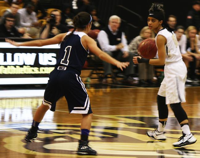 Darien Thompson, senior guard for the women’s basketball team, looks for an opening while Jessica Bianchi, sophomore women’s basketball player from Trinity Christian University, guards her.