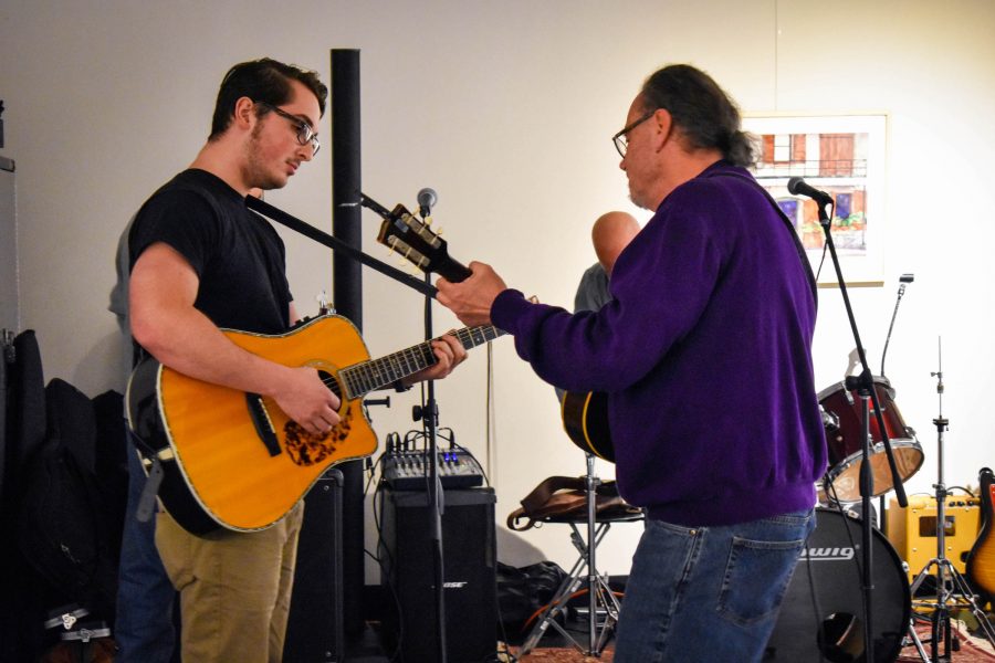 Marty Gomez (left) and Tom Roach, communication and creative arts department head (right), perform for the gallery guests. 