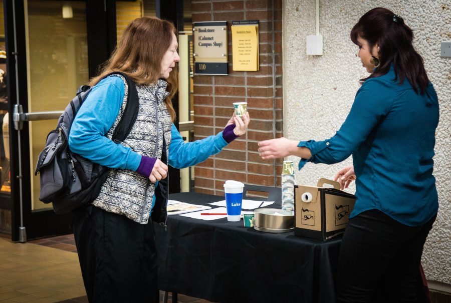 Kirsten Markusic, Social Justice Club president, serves students and teachers coffee samples. 