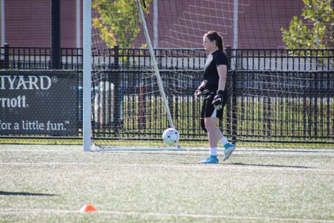 Lucie Ashmore, senior co-captain of the team, practices as goalkeeper before the season starts.