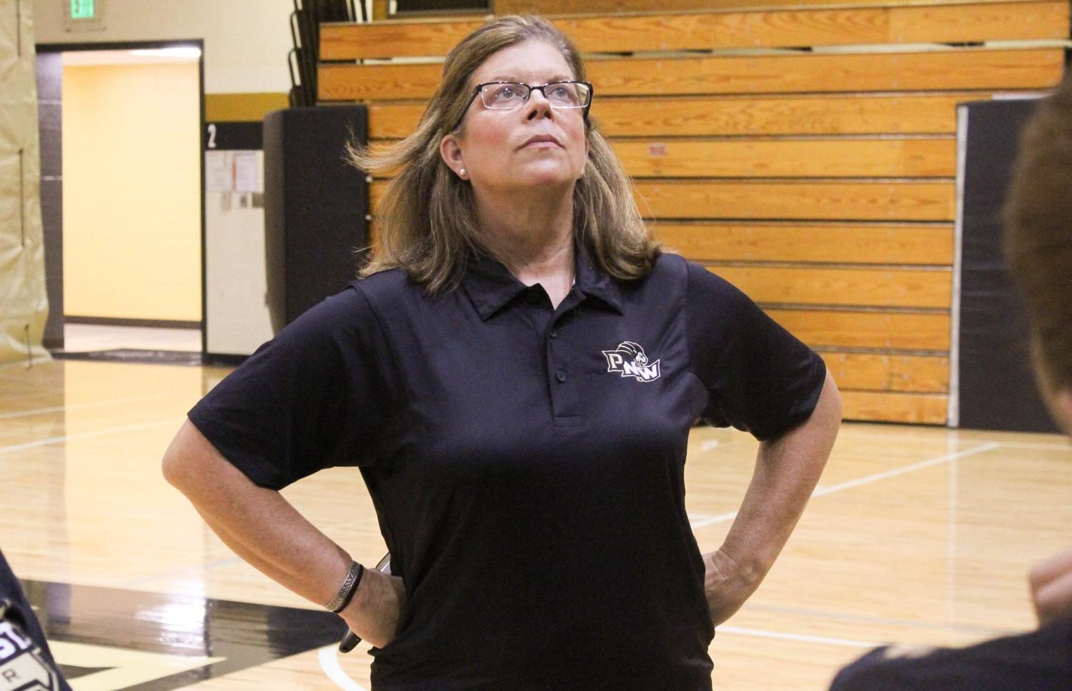 Michelle Searer, cheer coach, watches her team practice for the upcoming season.