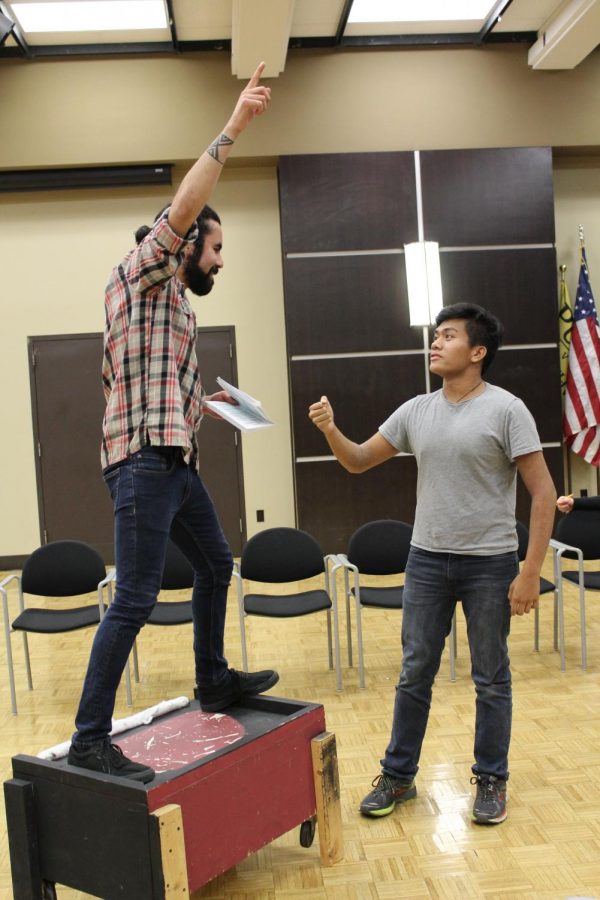 Robin Hood, played by Cristian Galvan (left), speaks to one of his Merry Men, played by Niko Cabela (right), about the upcoming archery competition to win the favor of Lady Marian.