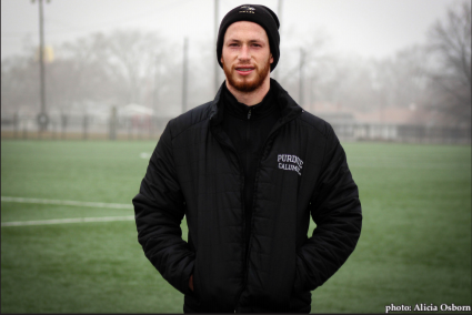 Miguel David, senior goalkeeper, stands outside in the fog.