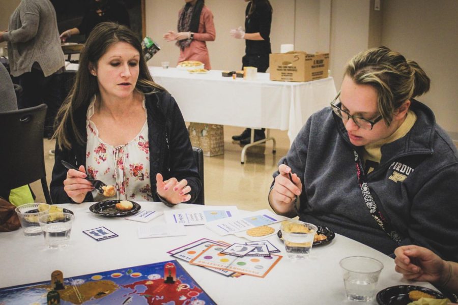 Cynthia Zdanczyk (left), assistant professor of psychology and Amanda Brown (right), senior
psychology major, try foods from around the world.