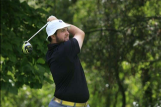 Patrick Mudd, PNW alum, practices his golf swing.