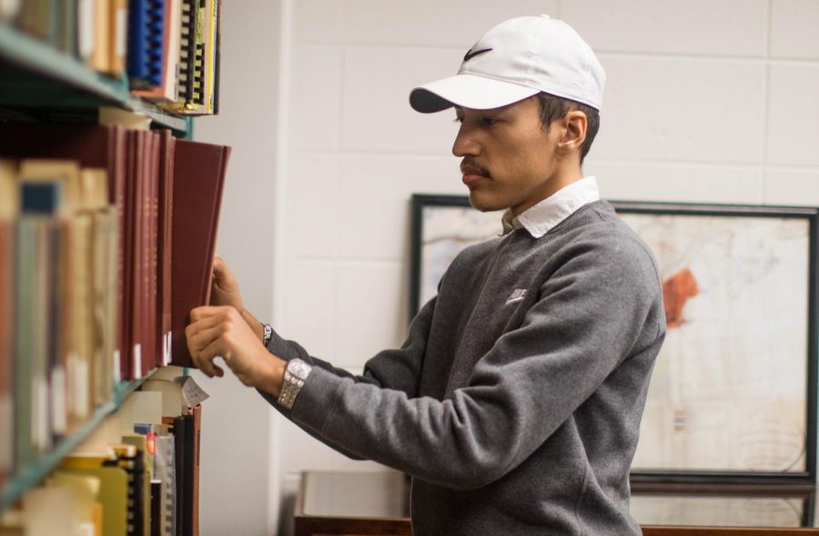 Jonathan Madera, junior
computer graphics technology major, peruses books in the
archive room on the Hammond campus.