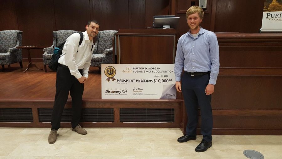 Jason Metz (left) and John Beutner (right) show off their winnings at Purdue University’s 31st
annual Burton D. Morgan Business Model Competition on Feb. 23.