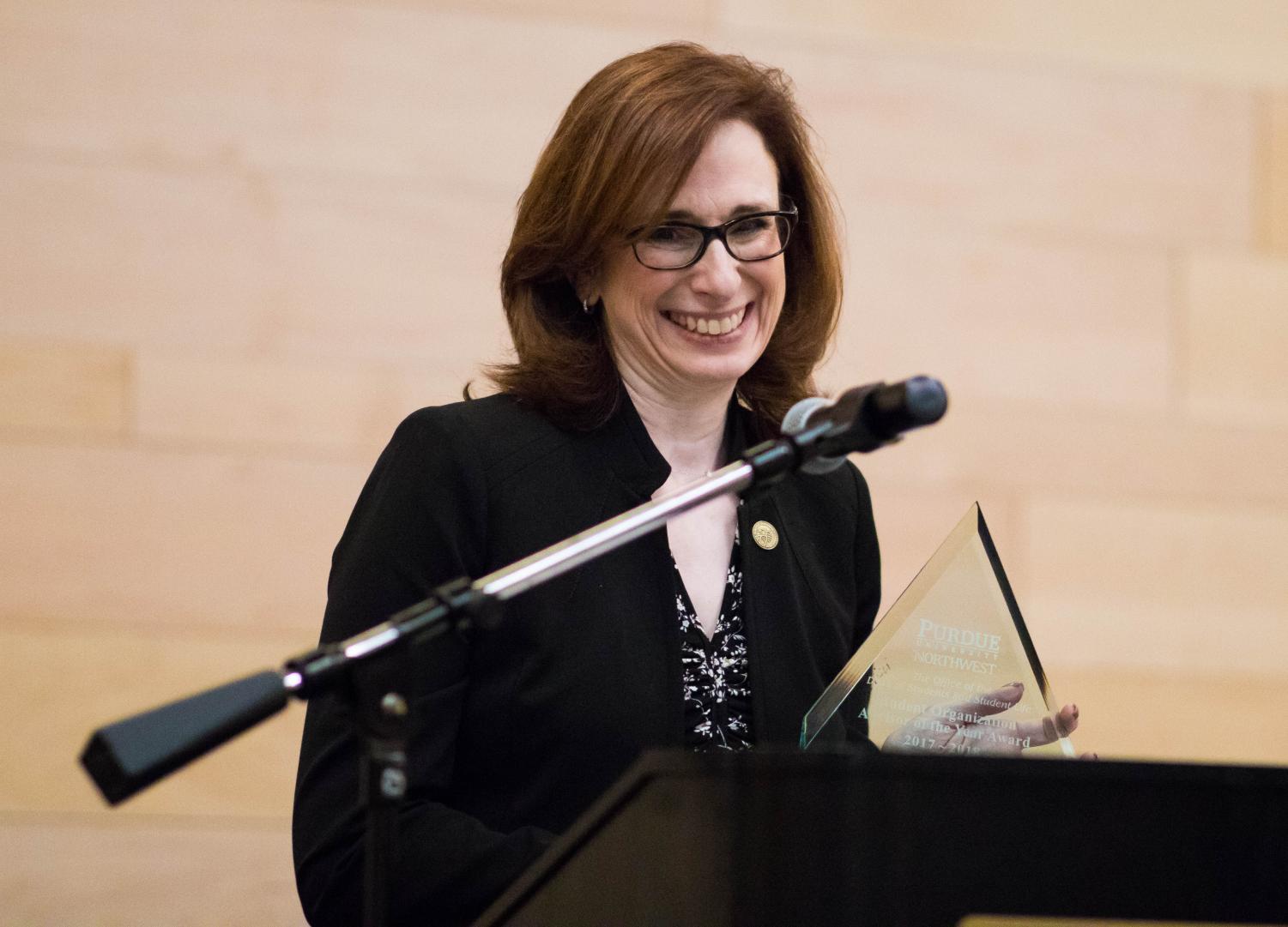 Lori Feldman, adviser for Women in Business and associate
vice chancellor for Academic Affairs, accepts the award for
Student Organization Adviser of the Year.
