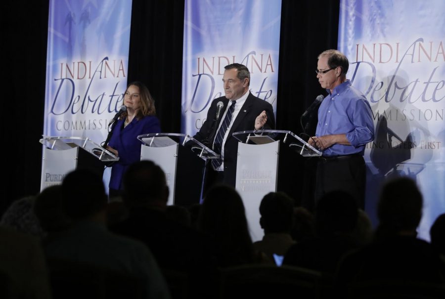 The three candidates running against each other debate topics of public interest on Oct. 8.