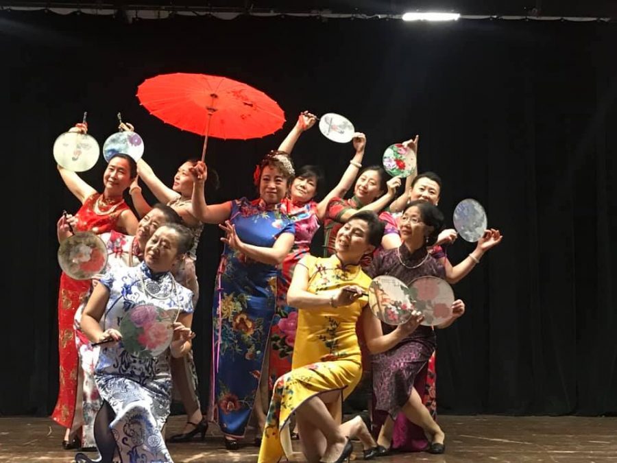 A dance team performs a Chinese traditional dress dance to celebrate the spring festival.