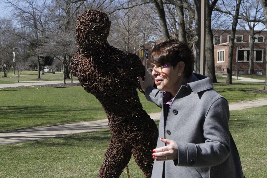 Judith Jacobi with “Boundless” by Boyan Marinov. Boundless is one of the sculptures on display at Hammond’s campus.