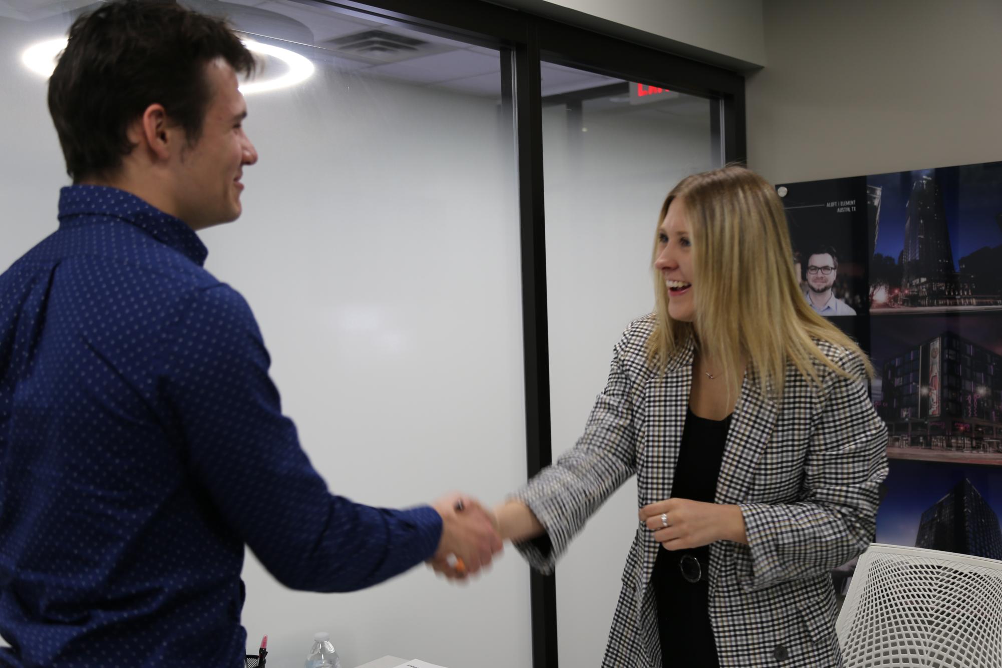 Nathan Tiltges and Kiersten Gora prepare for a round of sales simulation as a part of MKG 43300 Professional Selling. The class teaches students how to sell, a skill normally learned on the job.