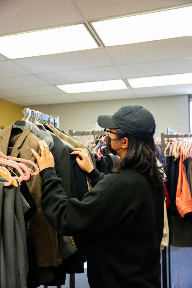 Students+getting+ready+for+job+interviews+or+important+presentations+can+browse+the+clothes+at+two+Career+Closets.+This+student+looks+for+options+in+the+Hammond+Closet+in+SULB.