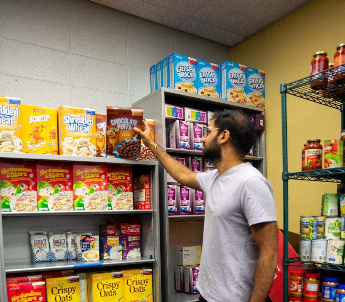 Vinay Teja Pathakamu, Student Life assistant, checks the stock at the PNW Food Pantry in SULB in Hammond. Donations of more than 3 tons of food have refilled the shelves.